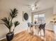 Dining area with modern light fixture, dining table, and sliding glass door to backyard at 1932 S Oswego Way, Aurora, CO 80014