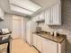 The kitchen features white brick detail and white appliances at 1932 S Oswego Way, Aurora, CO 80014