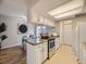 The kitchen is connected to the dining area, and has white cabinets at 1932 S Oswego Way, Aurora, CO 80014