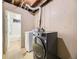 Convenient laundry area with modern washer and dryer, plus easy access to the bathroom at 1932 S Oswego Way, Aurora, CO 80014