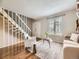 Cozy living room with hardwood floors, neutral paint, and staircase at 1932 S Oswego Way, Aurora, CO 80014
