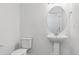 Powder room featuring a pedestal sink and toilet at 6902 Huddersfield Ln, Castle Pines, CO 80108