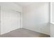 Neutral bedroom with carpeted floors and a closet with sliding doors at 6902 Huddersfield Ln, Castle Pines, CO 80108