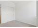 Neutral bedroom with carpeted floors and a closet with sliding doors at 6902 Huddersfield Ln, Castle Pines, CO 80108