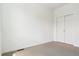 Minimalist bedroom with carpeted floors and a closet with sliding doors at 6902 Huddersfield Ln, Castle Pines, CO 80108