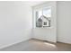 Neutral bedroom with carpeted floors and a window showcasing the neighborhood view at 6902 Huddersfield Ln, Castle Pines, CO 80108
