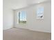 Bright bedroom featuring neutral carpet, large windows and white walls at 6902 Huddersfield Ln, Castle Pines, CO 80108