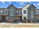 Modern townhome featuring large windows and neutral gray and white siding at 6902 Huddersfield Ln, Castle Pines, CO 80108