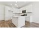 Open kitchen with white cabinets, an island, and stainless steel appliances at 6902 Huddersfield Ln, Castle Pines, CO 80108