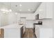Modern kitchen with white cabinets, stainless steel appliances, and a center island at 6902 Huddersfield Ln, Castle Pines, CO 80108