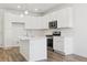 Bright, modern kitchen with white cabinetry, island, and stainless steel appliances at 6902 Huddersfield Ln, Castle Pines, CO 80108