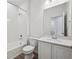 Bathroom featuring a shower-tub combo, white tile, modern vanity and lighting at 1368 Penner Dr, Erie, CO 80026