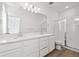 Modern bathroom with double sink vanity, large mirror, tiled floors, and a glass-enclosed shower at 1368 Penner Dr, Erie, CO 80026