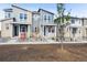 Charming modern townhomes featuring stylish exteriors, well-manicured landscaping, and welcoming front porches at 1368 Penner Dr, Erie, CO 80026