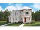 New construction home with modern design elements and covered front porch, nestled among mature trees at 1368 Penner Dr, Erie, CO 80026