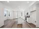 Open-concept kitchen featuring a center island, stainless steel appliances, and hardwood floors at 1368 Penner Dr, Erie, CO 80026