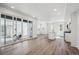 Open floor plan with hardwood floors, flowing from the living area to the modern kitchen at 1368 Penner Dr, Erie, CO 80026