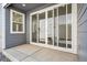 Covered patio features sliding glass doors, stone pavers, and gray siding, perfect for outdoor relaxation at 1368 Penner Dr, Erie, CO 80026