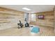 Basement exercise room with exercise bike, television and wood accent wall at 3727 Starry Night Loop, Castle Rock, CO 80109