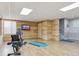 Basement exercise room with exercise bike, television and wood accent wall at 3727 Starry Night Loop, Castle Rock, CO 80109