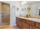 This bathroom features a double sink vanity, framed mirrors and a tiled walk-in shower at 3727 Starry Night Loop, Castle Rock, CO 80109
