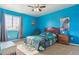 This bedroom features bright blue walls and natural light at 3727 Starry Night Loop, Castle Rock, CO 80109