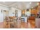 Inviting kitchen with a dining area, granite countertops, wood cabinets, stainless steel appliances, and hardwood floors at 3727 Starry Night Loop, Castle Rock, CO 80109