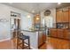 Modern kitchen featuring a center island, stainless steel appliances, wood cabinets, and granite countertops at 3727 Starry Night Loop, Castle Rock, CO 80109