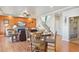 Bright open-concept living and dining area with a stone fireplace and a staircase to the second floor at 3727 Starry Night Loop, Castle Rock, CO 80109