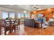 Open-concept living area with hardwood floors, a stone fireplace, and large windows for natural light at 3727 Starry Night Loop, Castle Rock, CO 80109