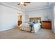 This main bedroom features neutral carpeting, a ceiling fan, and an ensuite bathroom at 3727 Starry Night Loop, Castle Rock, CO 80109