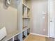 Functional mudroom with built-in shelving, bench seating, and convenient storage space with tile flooring at 3727 Starry Night Loop, Castle Rock, CO 80109
