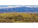 A view of rolling hills with snow-capped mountains in the distance at 3727 Starry Night Loop, Castle Rock, CO 80109