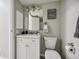 A gray-toned powder room featuring a white vanity and chrome light fixture at 4274 S Salida Way # 6, Aurora, CO 80013