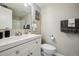 Half bath featuring a white vanity, matching toilet, and decorative accents at 4274 S Salida Way # 6, Aurora, CO 80013