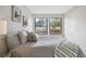 Bright bedroom featuring two windows, grey bedding, and neutral decor at 4274 S Salida Way # 6, Aurora, CO 80013