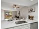 This modern kitchen showcases white cabinetry, stainless steel appliances, and a quartz countertop at 4274 S Salida Way # 6, Aurora, CO 80013