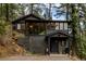 Stunning exterior view of a modern home nestled among mature trees and natural landscaping at 7869 S Turkey Creek Rd, Morrison, CO 80465
