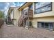 Back exterior with stairs and gravel at 6594 W Mississippi Way, Lakewood, CO 80232