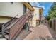 Back exterior with stairs and gravel at 6594 W Mississippi Way, Lakewood, CO 80232