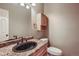 Small bathroom with granite countertop and dark vanity at 6594 W Mississippi Way, Lakewood, CO 80232