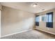 Simple carpeted bedroom with a window and neutral walls at 6594 W Mississippi Way, Lakewood, CO 80232