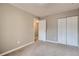 Spacious bedroom with double doors and neutral walls at 6594 W Mississippi Way, Lakewood, CO 80232