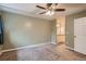 Primary bedroom with ceiling fan and ensuite bath at 6594 W Mississippi Way, Lakewood, CO 80232