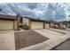 Front view of townhouses with attached garages and landscaping at 6594 W Mississippi Way, Lakewood, CO 80232