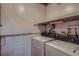 Laundry area with washer, dryer, and overhead shelving at 6594 W Mississippi Way, Lakewood, CO 80232