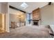 Living room features a stone fireplace, vaulted ceiling, and skylight at 6594 W Mississippi Way, Lakewood, CO 80232