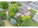 Aerial view of a home showcasing its large fenced backyard, patio area, and mature trees at 10694 E Dorado Ave, Englewood, CO 80111