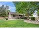 Well-kept backyard with green lawn, shrubbery, and privacy fence providing a serene outdoor space at 10694 E Dorado Ave, Englewood, CO 80111