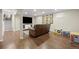 Basement featuring living area, staircase, toys, and white storage cabinet at 10694 E Dorado Ave, Englewood, CO 80111